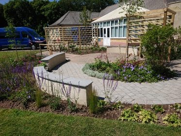 rendered wall, curved wall, sandstone paving, planting, granite, water feature, trellis, salvia, woodland